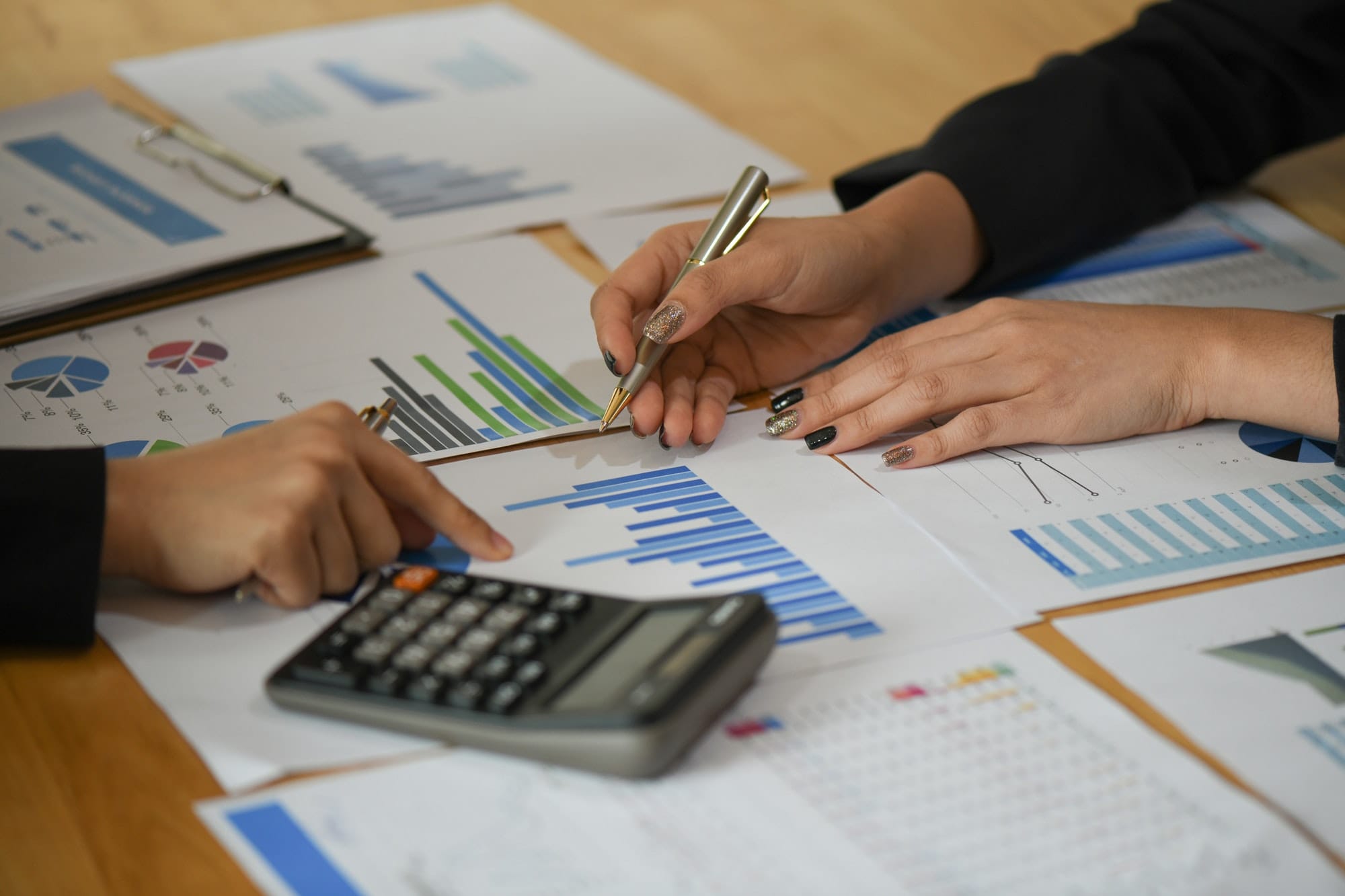 Cropped shot of Accounting staff are using calculators and graphing to pay annual taxes.